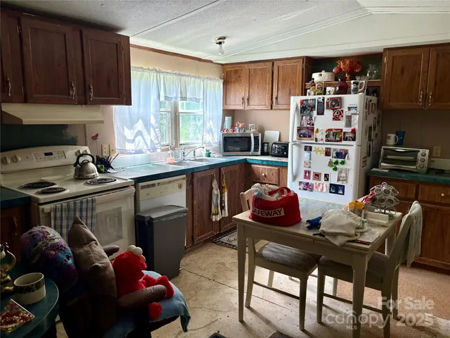 a kitchen with a sink cabinets and window