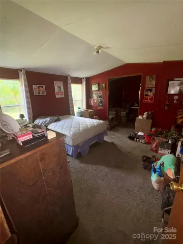 a living room with furniture a window and a flat screen tv