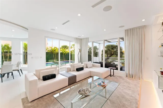 a living room with furniture and large windows