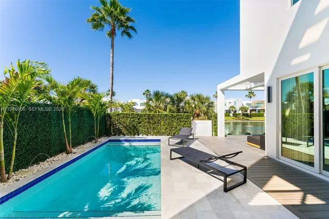 a swimming pool view with a garden space