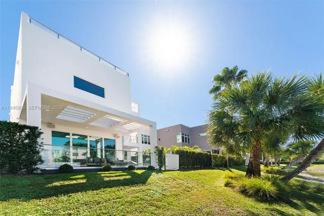 a living room with patio furniture and a large window