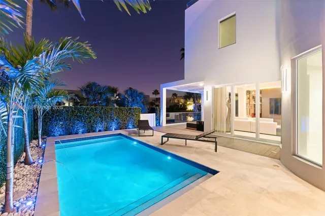 a living room with furniture and potted plants