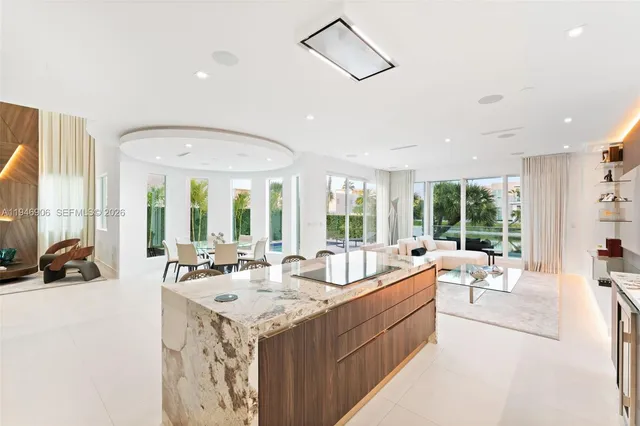 a large white kitchen with a large window