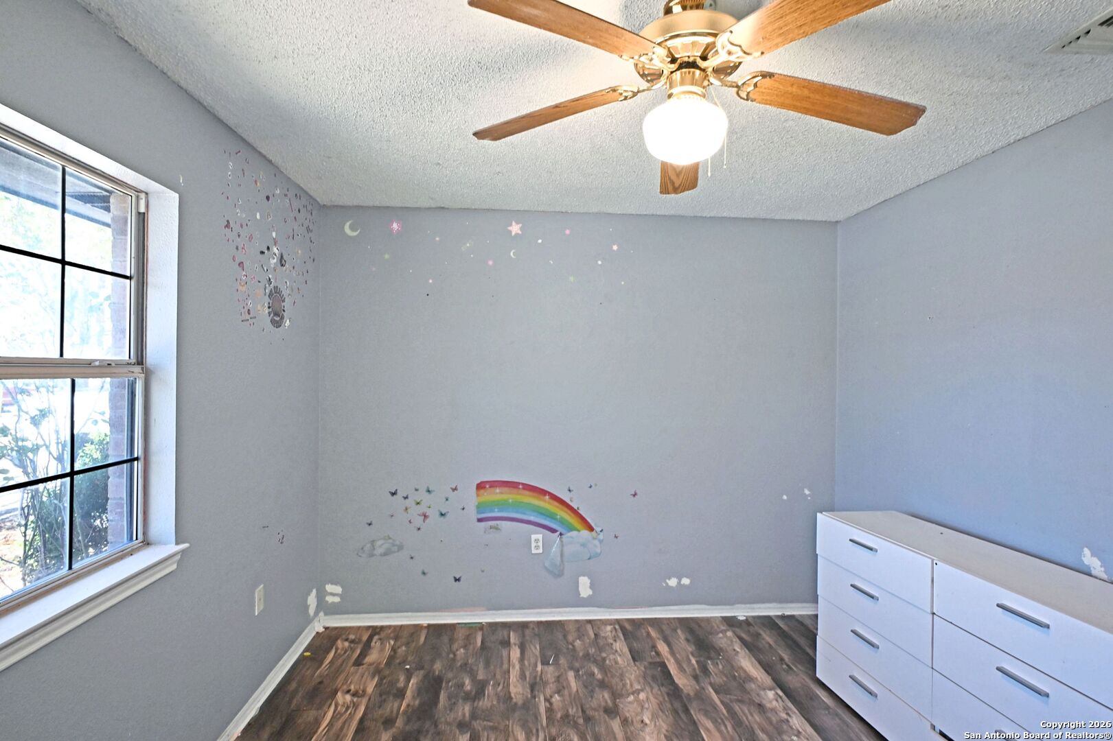 2229 Michigan Street New Braunfels, TX 78130 - Photo 11 of 19 wooden floor in an empty room with a window