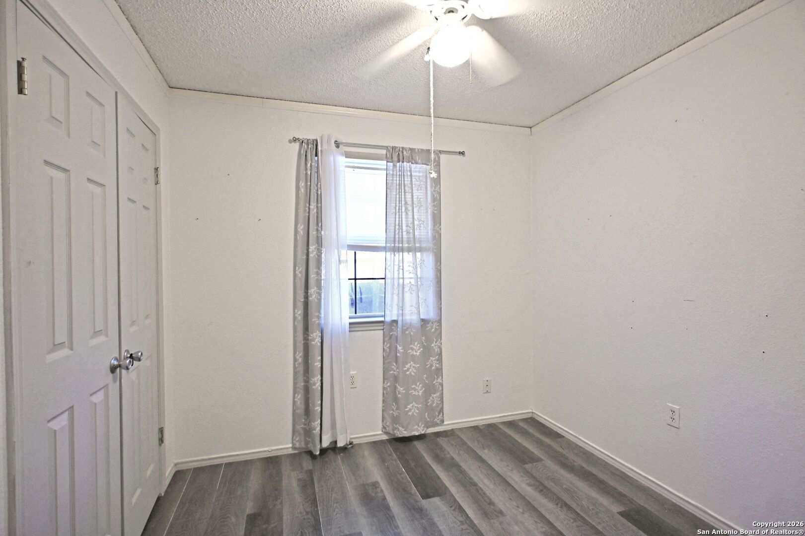 2229 Michigan Street New Braunfels, TX 78130 - Photo 13 of 19 a view of an empty room with wooden floor