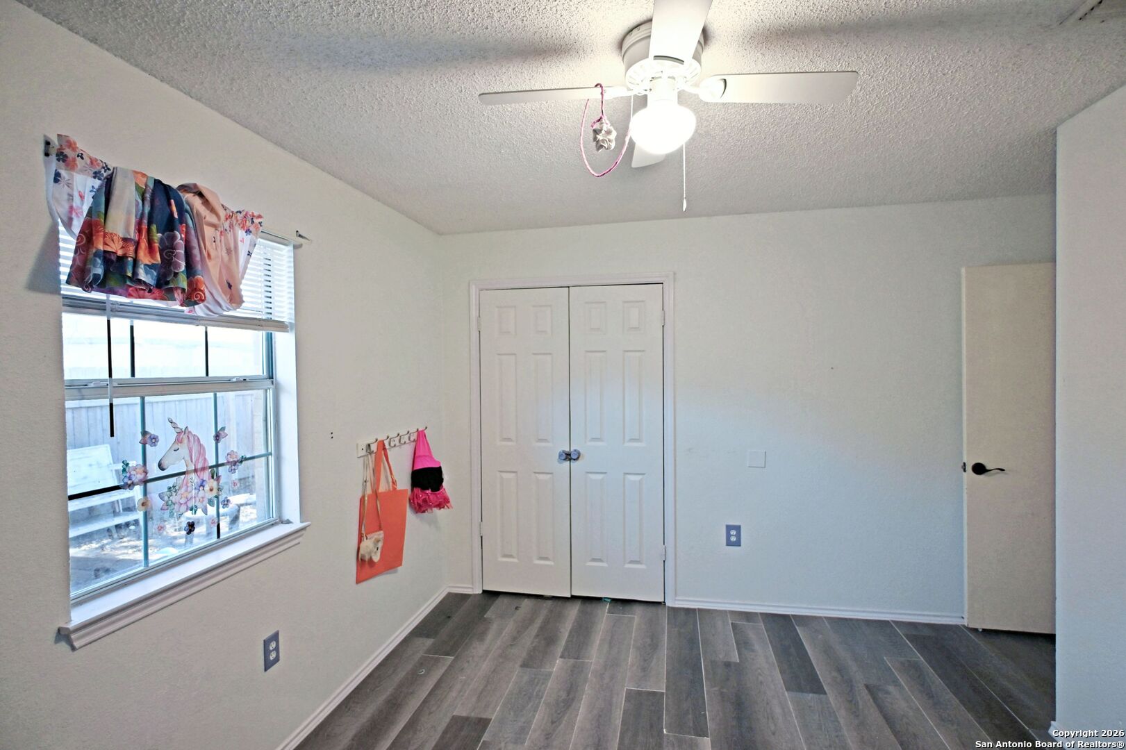 2229 Michigan Street New Braunfels, TX 78130 - Photo 14 of 19 wooden floor in an empty room with a window