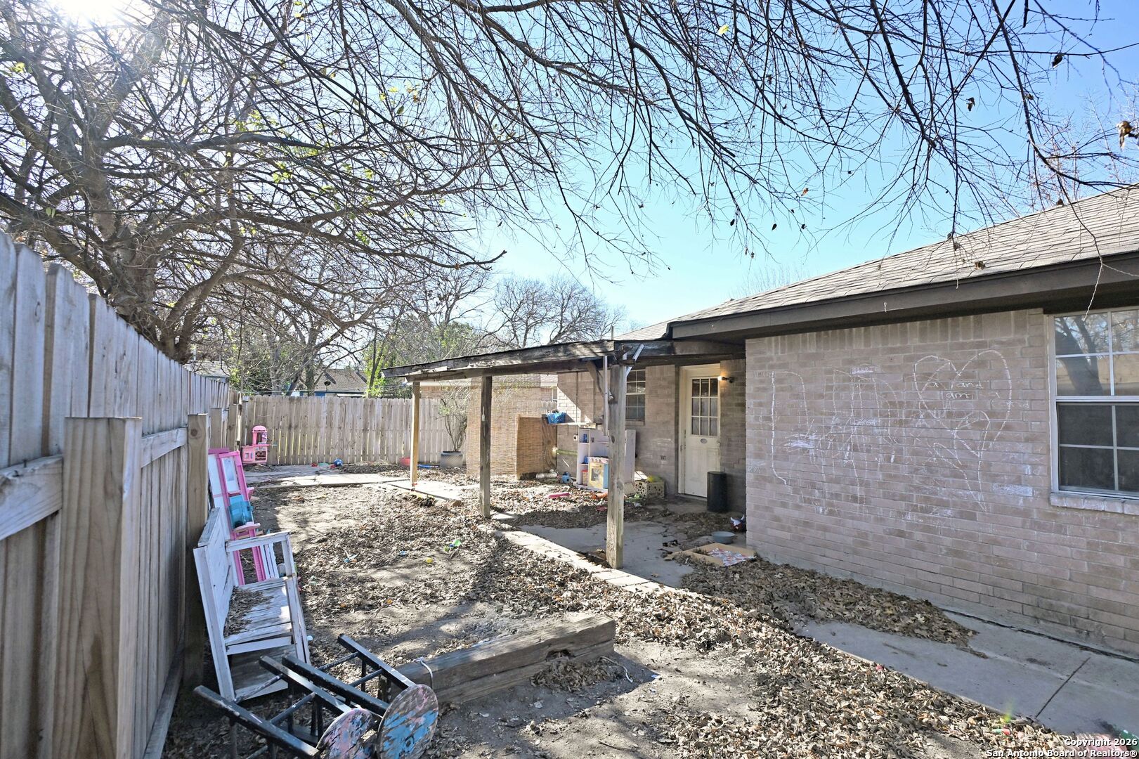 2229 Michigan Street New Braunfels, TX 78130 - Photo 19 of 19 a view of a backyard with wooden fence and large tree