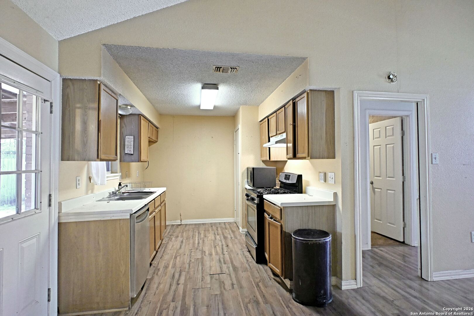 2229 Michigan Street New Braunfels, TX 78130 - Photo 5 of 19 a kitchen with a sink stove and cabinets