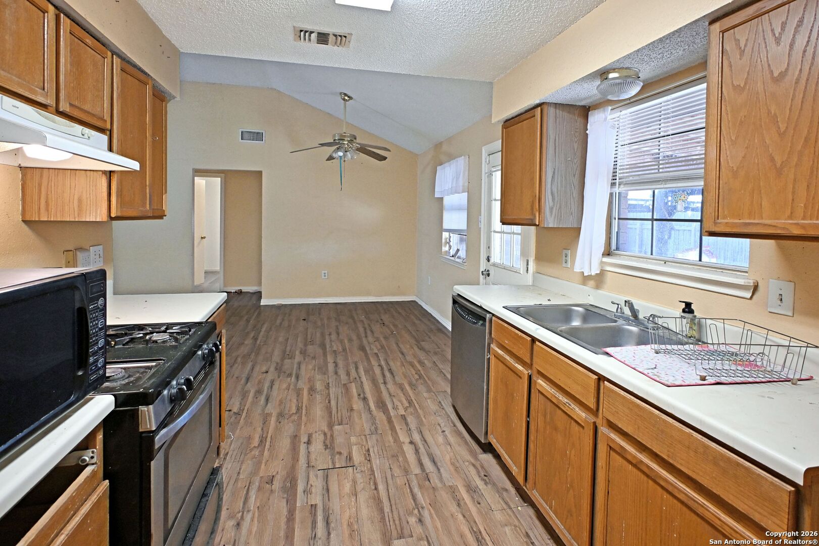 2229 Michigan Street New Braunfels, TX 78130 - Photo 6 of 19 a kitchen with a sink stove top oven and cabinets