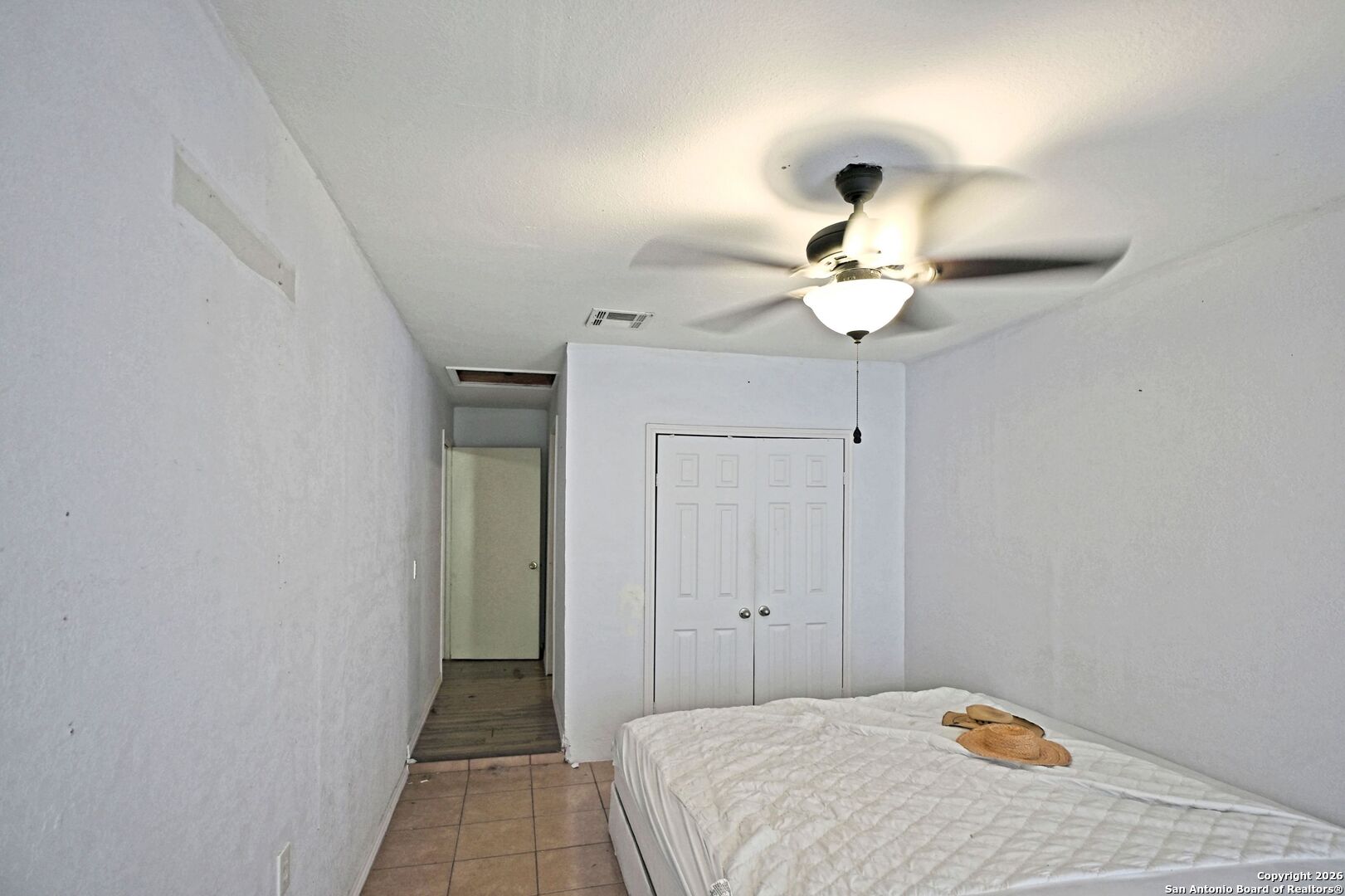 2229 Michigan Street New Braunfels, TX 78130 - Photo 8 of 19 a bedroom with a bed and a chandelier