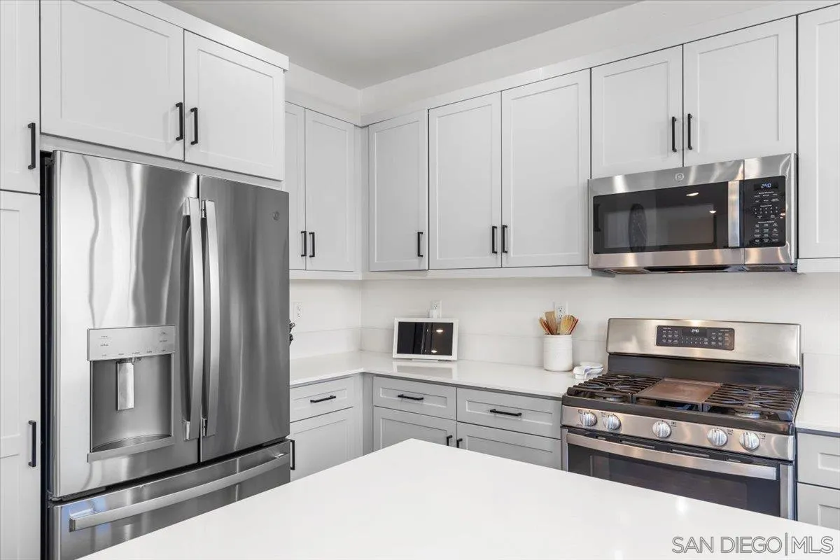 108 Lipizzan Lane Fallbrook, CA 92028 - Photo 12 of 37 a kitchen with stainless steel appliances a refrigerator stove and microwave