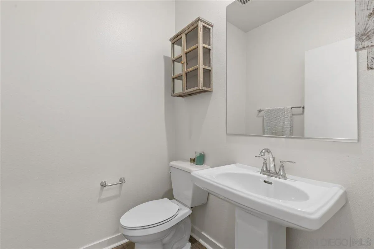 108 Lipizzan Lane Fallbrook, CA 92028 - Photo 13 of 37 a bathroom with a toilet sink and mirror
