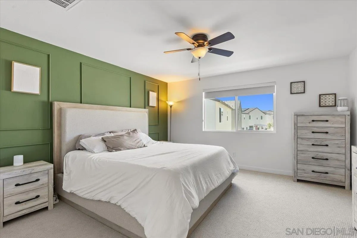 108 Lipizzan Lane Fallbrook, CA 92028 - Photo 17 of 37 a bedroom with a bed and a chandelier