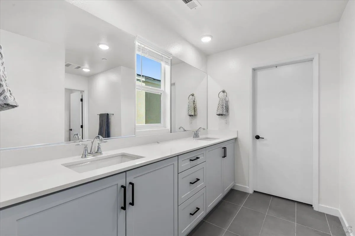 108 Lipizzan Lane Fallbrook, CA 92028 - Photo 19 of 37 a bathroom with a double vanity sink and mirror