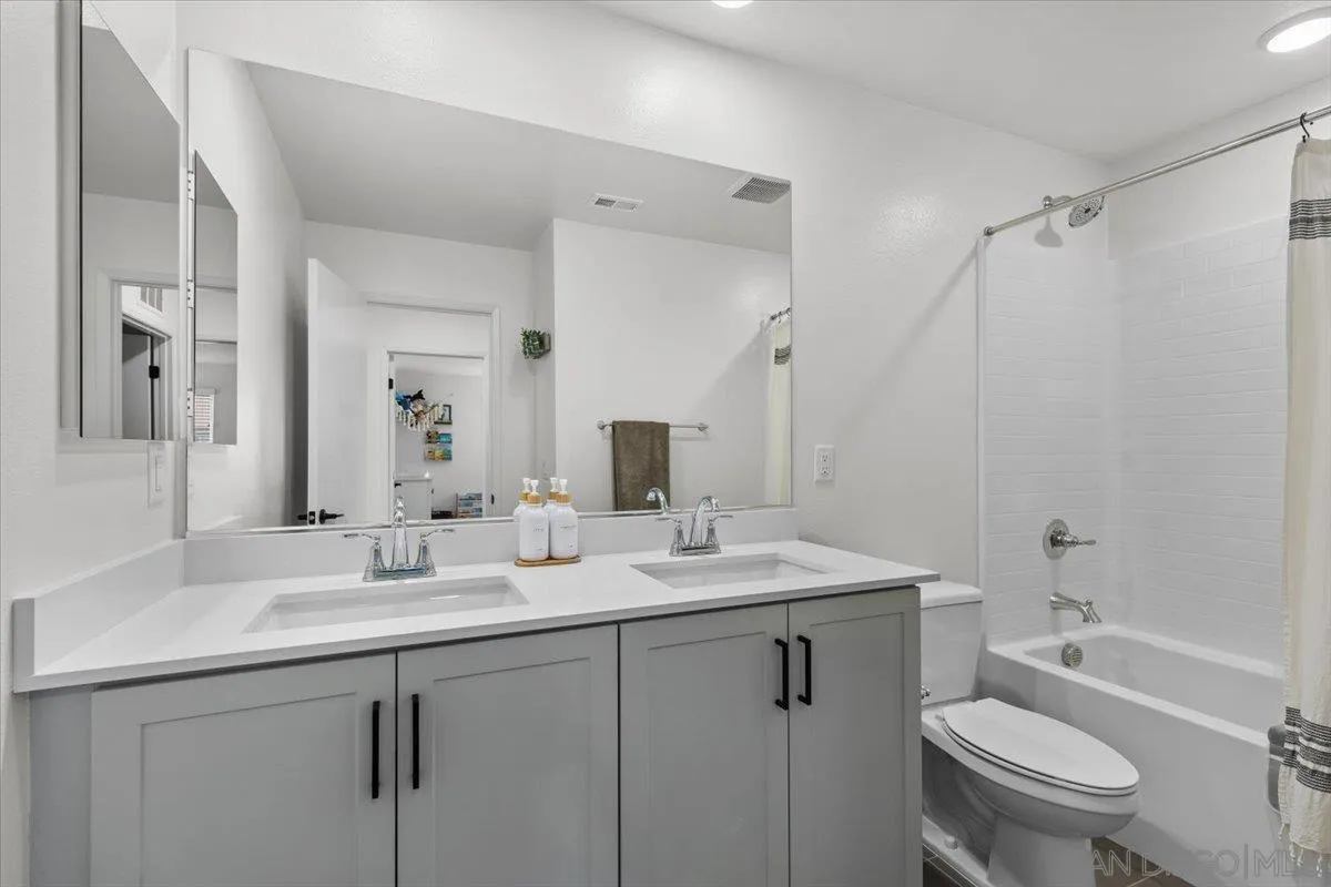 108 Lipizzan Lane Fallbrook, CA 92028 - Photo 21 of 37 a bathroom with a double vanity sink toilet and a mirror