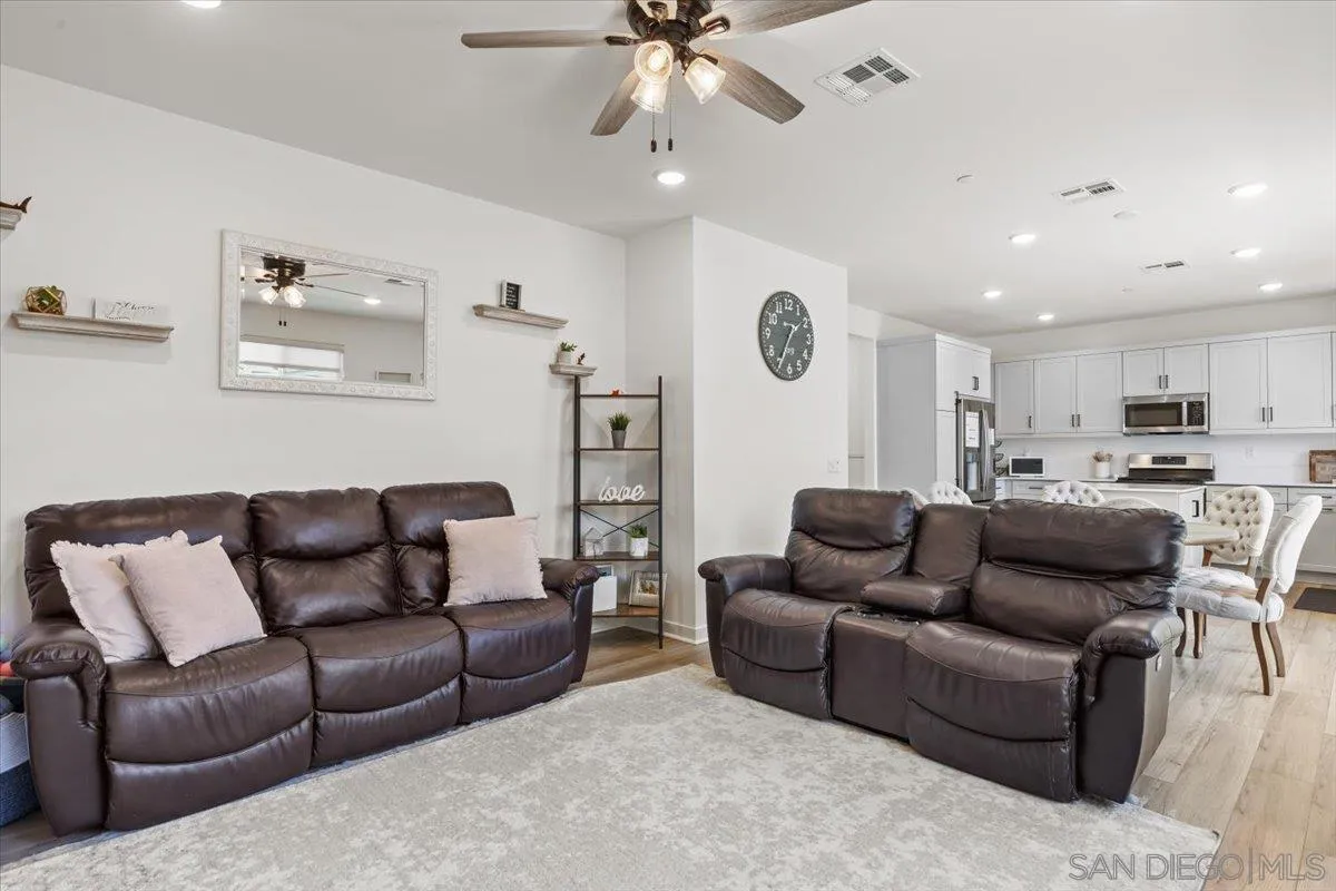 108 Lipizzan Lane Fallbrook, CA 92028 - Photo 9 of 37 a living room with furniture ceiling fan and a rug