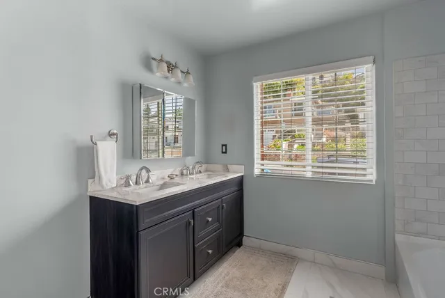 a bathroom with a sink a vanity and a window