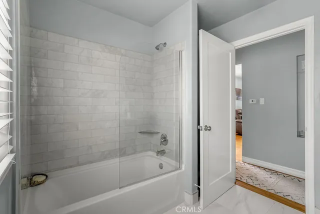 a bathroom with a bathtub and shower
