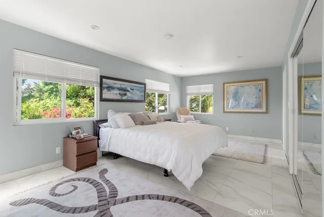 a spacious bedroom with a bed and a couch