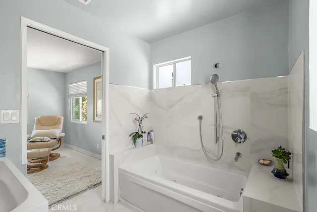 a bathroom with a bathtub and shower