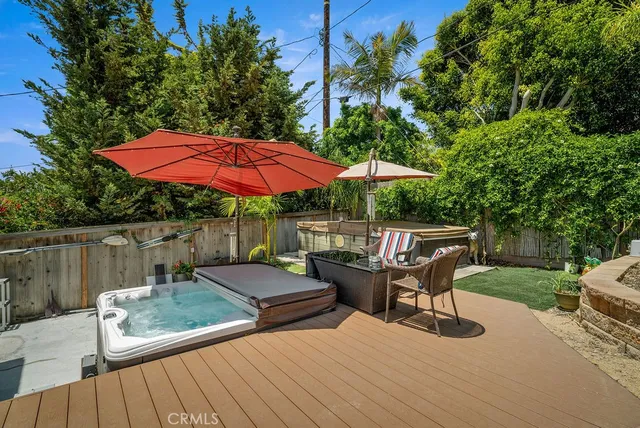 a view of backyard with seating space and wooden fence