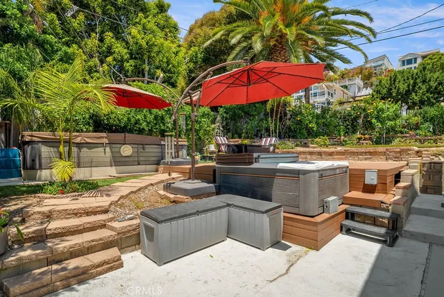 a patio with a table and chairs under an umbrella