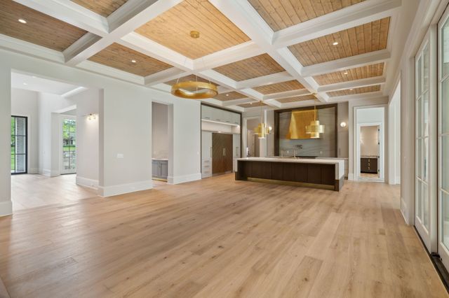 a view of an empty room with a fireplace and a window