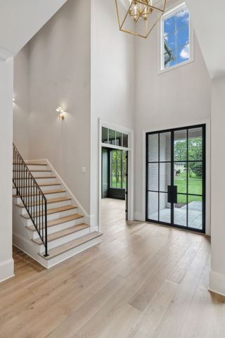 a view of an empty room with chandelier