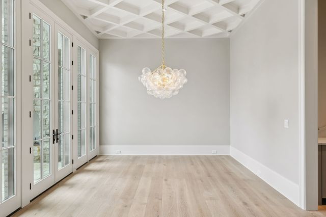 a view of a bathroom with mirror and shower