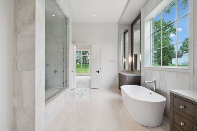 a spacious bathroom with a bathtub and a shower
