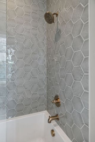 a view of an empty room with a fireplace and windows