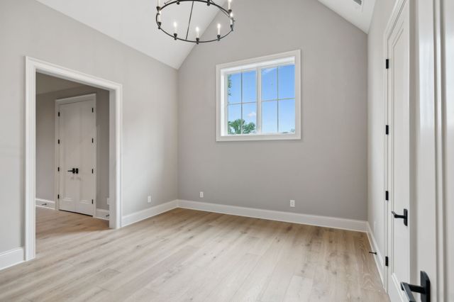 a view of an empty room with a fireplace and a yard