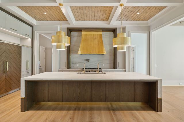 a room with a sink a bed and a mirror