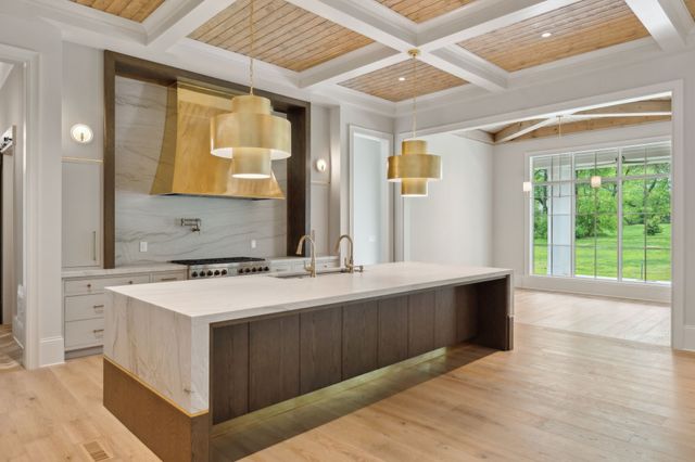 a kitchen with a sink and a stove top oven