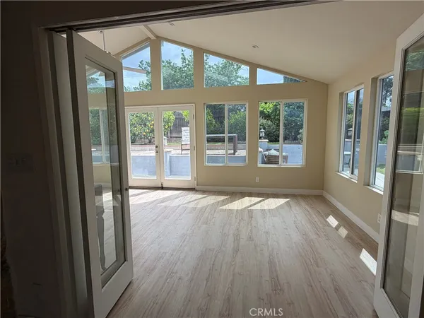 a view of an entryway with wooden floor and door