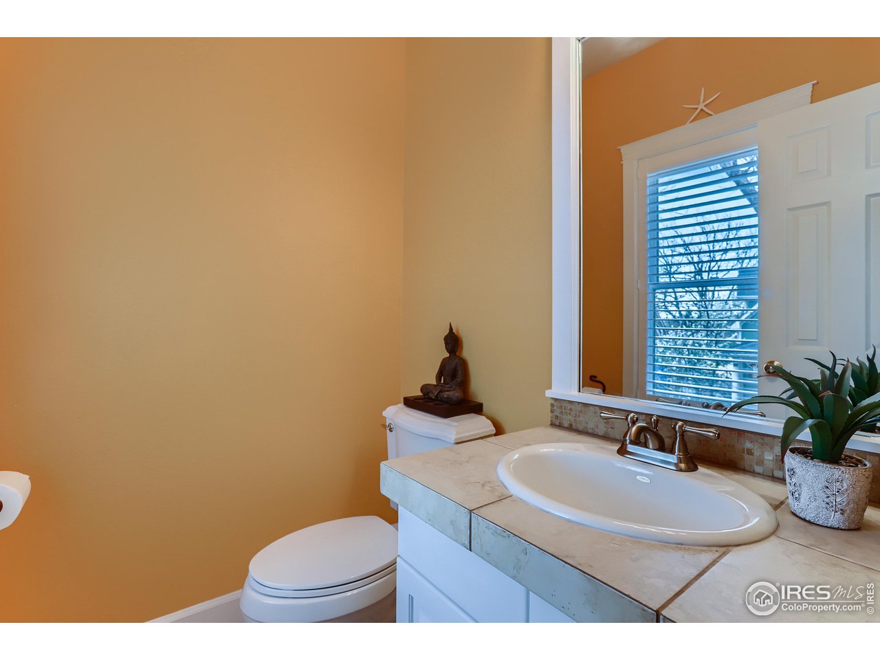 1109 Mapleton Avenue Boulder, CO 80304 - Photo 11 of 27 a bathroom with a sink a toilet and mirror