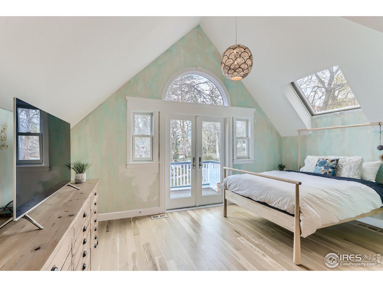 1109 Mapleton Avenue Boulder, CO 80304 - Photo 12 of 27 a bedroom with a bed and a large mirror on the dresser