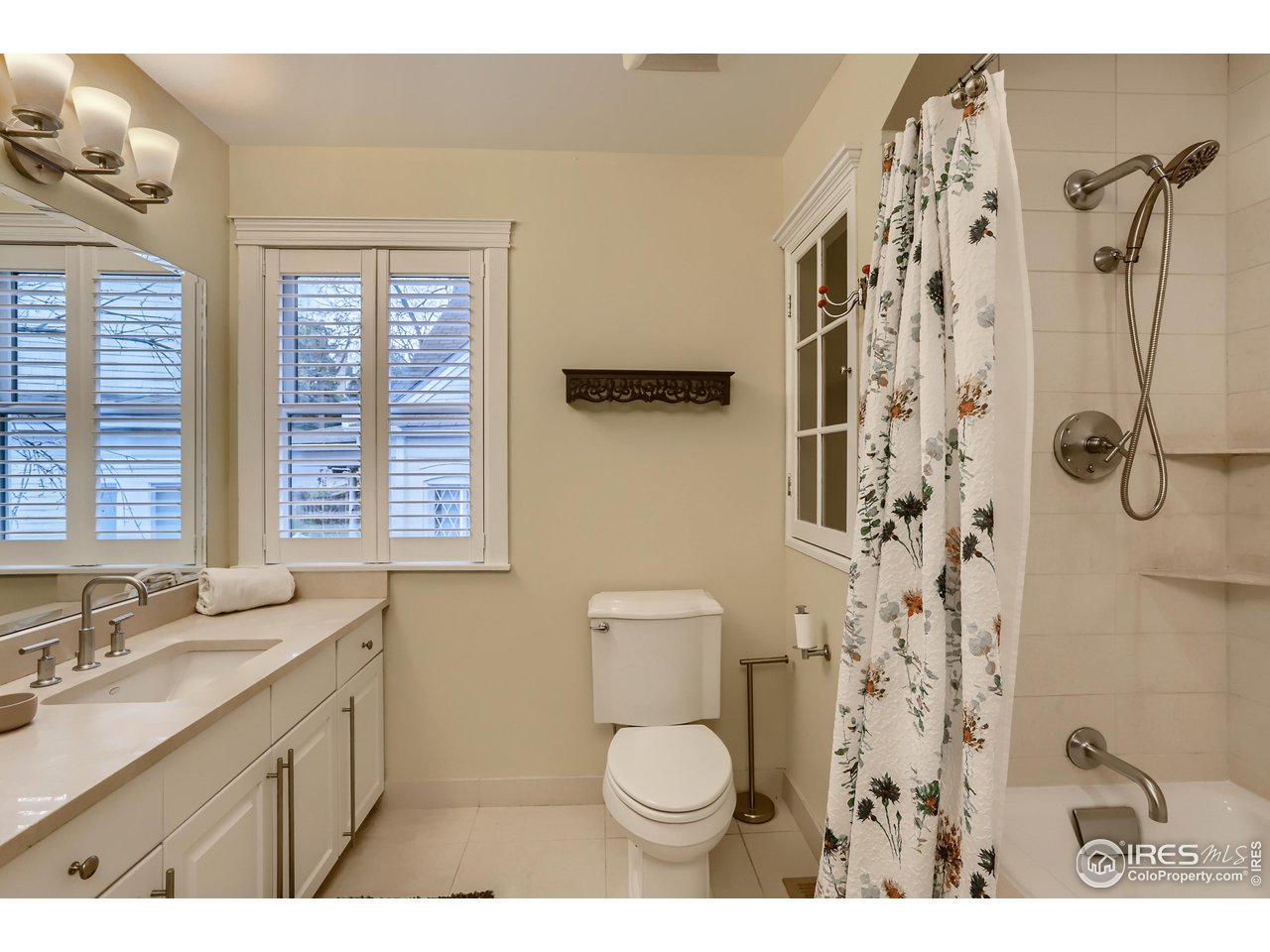 1109 Mapleton Avenue Boulder, CO 80304 - Photo 16 of 27 a bathroom with a granite countertop sink toilet and shower