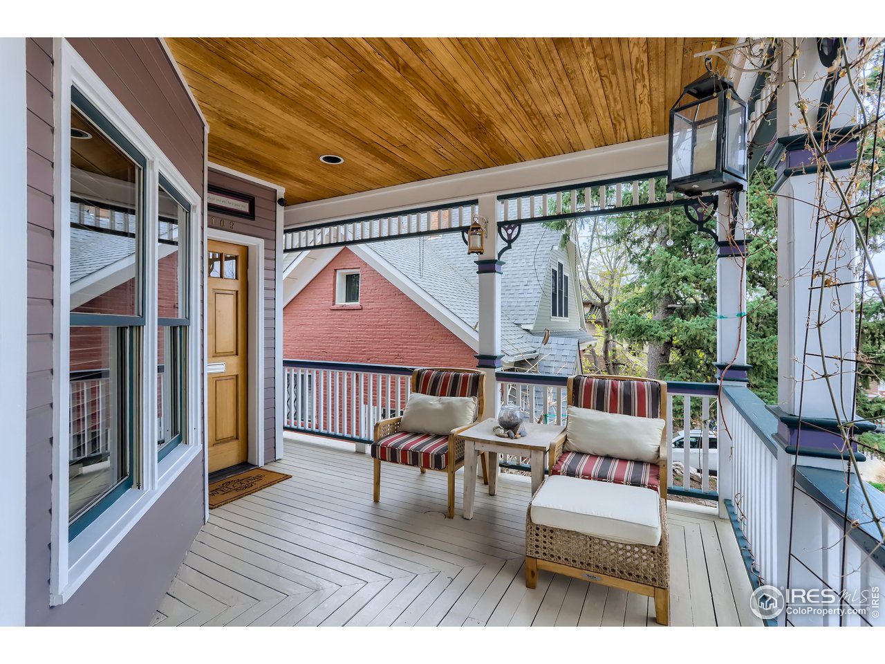 1109 Mapleton Avenue Boulder, CO 80304 - Photo 2 of 27 a balcony with furniture and a wooden floor