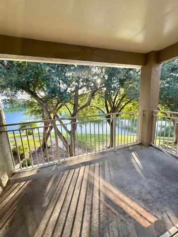 a view of porch with a floor to ceiling window next to a yard