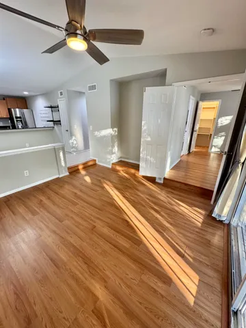 a view of a livingroom with an empty space and a ceiling fan
