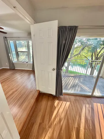 a view of outdoor space with wooden floor and windows