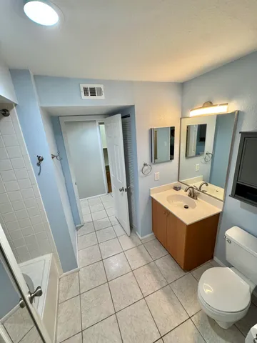 a bathroom with a sink mirror and tub