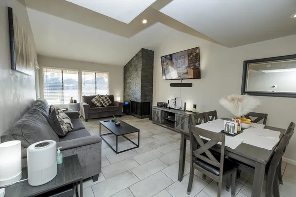 a living room with furniture a large window and a flat screen tv