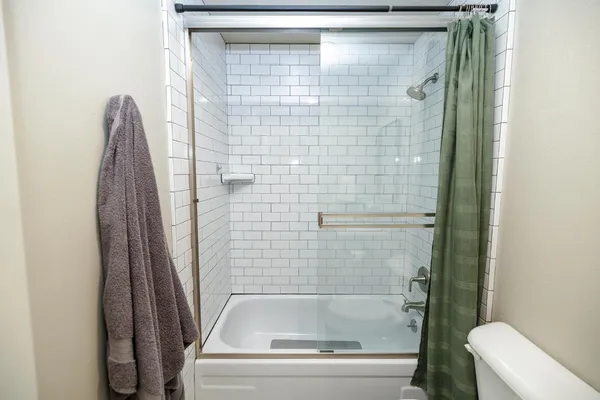 a bathroom with a shower and toilet