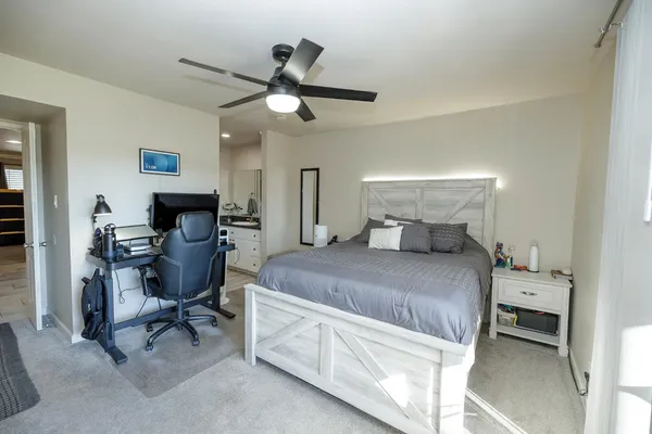 a bedroom with a bed and a chandelier