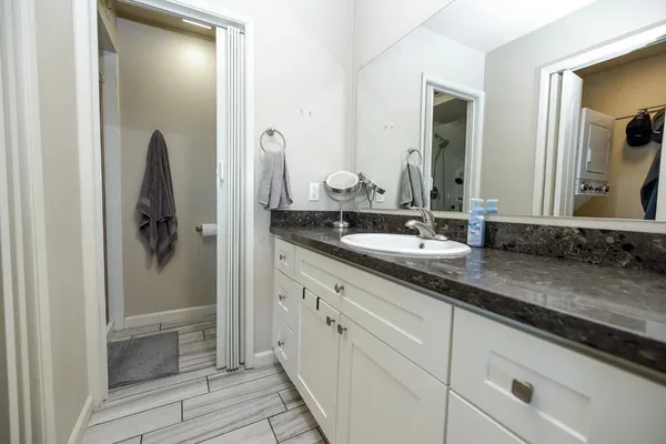 a bathroom with a double vanity sink and mirror