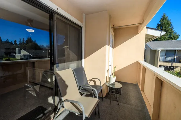 a balcony with table and chairs