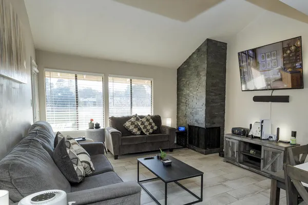 a living room with furniture and a floor to ceiling window