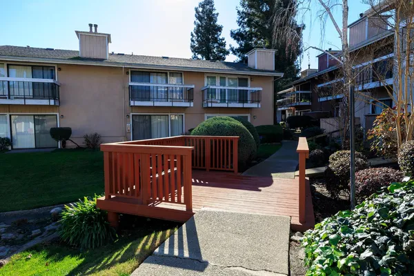 a view of a house with backyard and sitting area